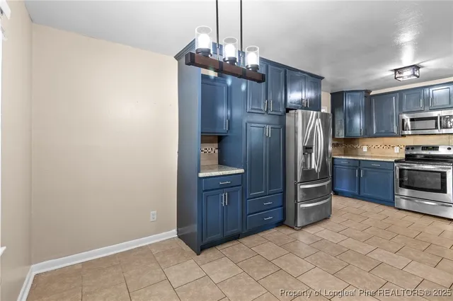a kitchen with stainless steel appliances a refrigerator and wooden cabinets