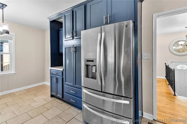 a metallic refrigerator freezer sitting in a kitchen