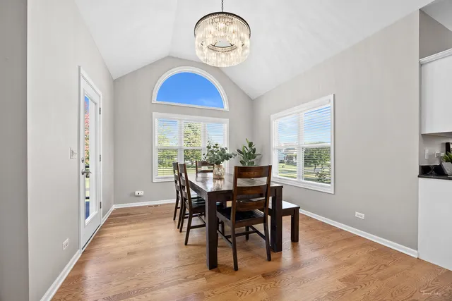 a living room with furniture a fireplace and a potted plant