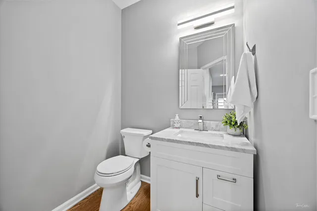a view of a hallway with wooden floor and windows