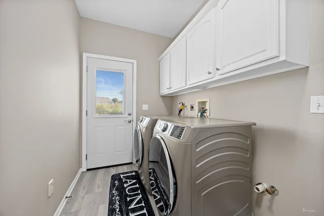 a view of a hallway with wooden floor and windows