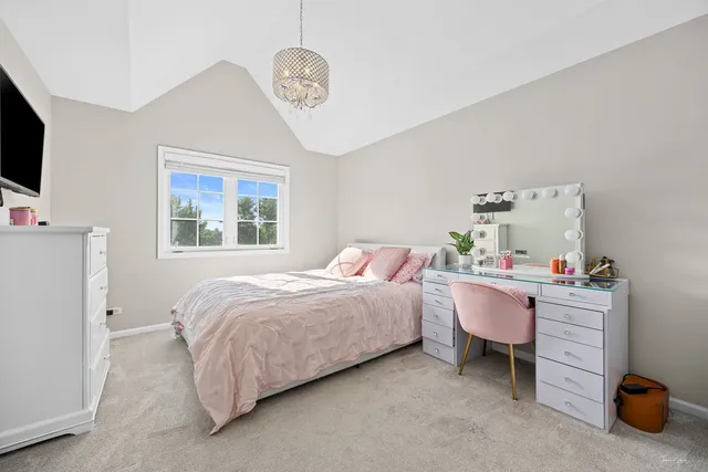 a kitchen with granite countertop a table chairs sink and window