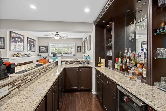 a view of a balcony with wooden floor and outdoor seating