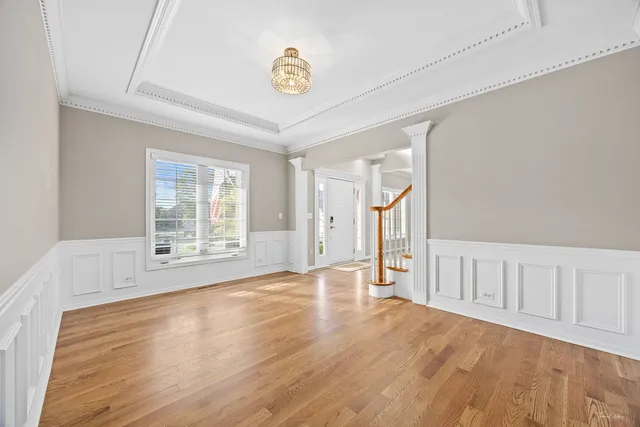 a view of a hallway with wooden floor and entryway