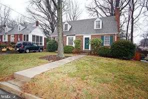 a front view of a house with yard and green space