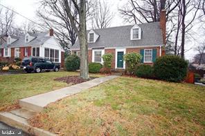 a front view of a house with yard and green space