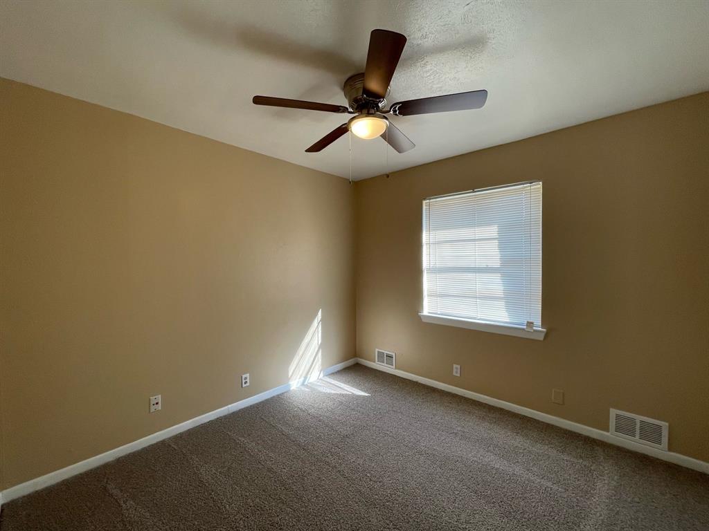 2310 Gilbert Circle Arlington, TX 76010 - Photo 7 of 9 Unfurnished room with carpet flooring and ceiling fan