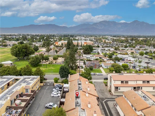 an aerial view of a house with a garden and lake view