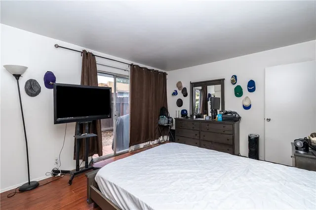 a bedroom with a bed and a flat screen tv