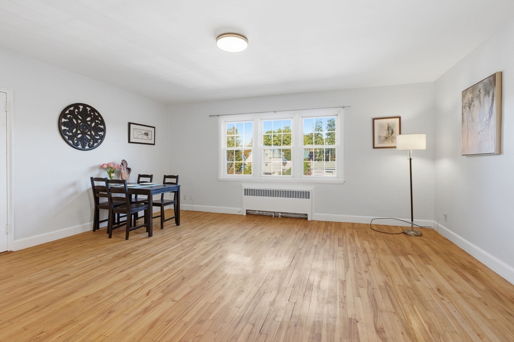 112 Maple Street, Unit 6 Malden, MA 02148 - Photo 7 of 22 a view of a livingroom with furniture and wooden floor