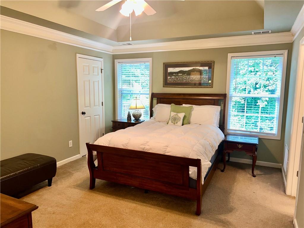 113 Nelson Ridge Drive Ball Ground, GA 30107 - Photo 16 of 33 a bed sitting in a bedroom next to a window