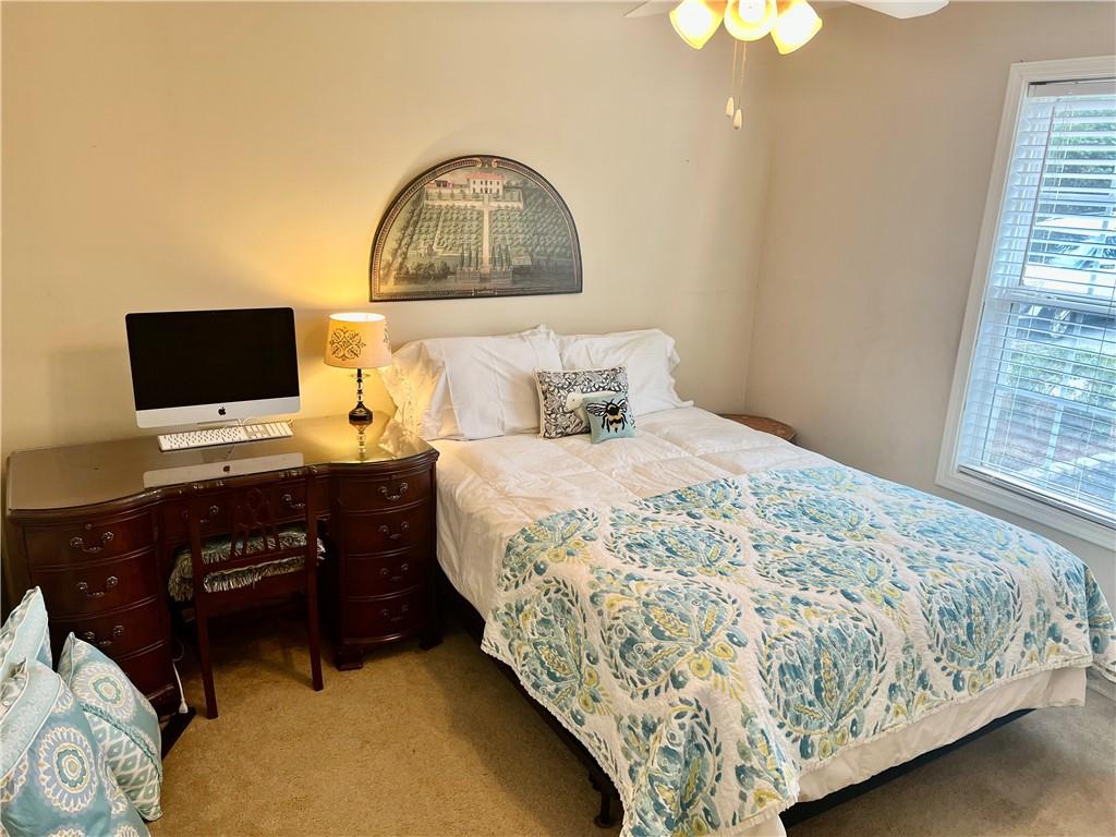 113 Nelson Ridge Drive Ball Ground, GA 30107 - Photo 20 of 33 a bedroom with a bed and a flat tv screen on dresser