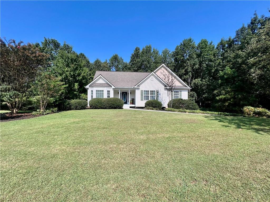 113 Nelson Ridge Drive Ball Ground, GA 30107 - Photo 2 of 33 a front view of house with yard and green space
