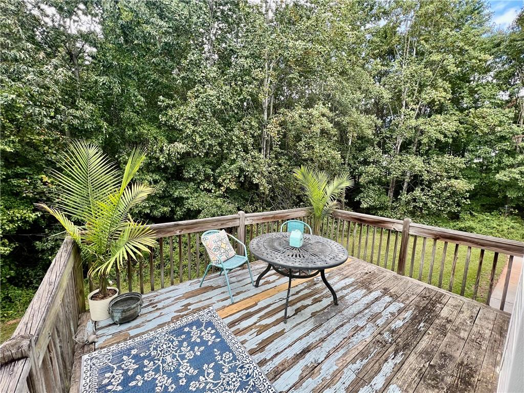 113 Nelson Ridge Drive Ball Ground, GA 30107 - Photo 27 of 33 a balcony with wooden floor and outdoor seating