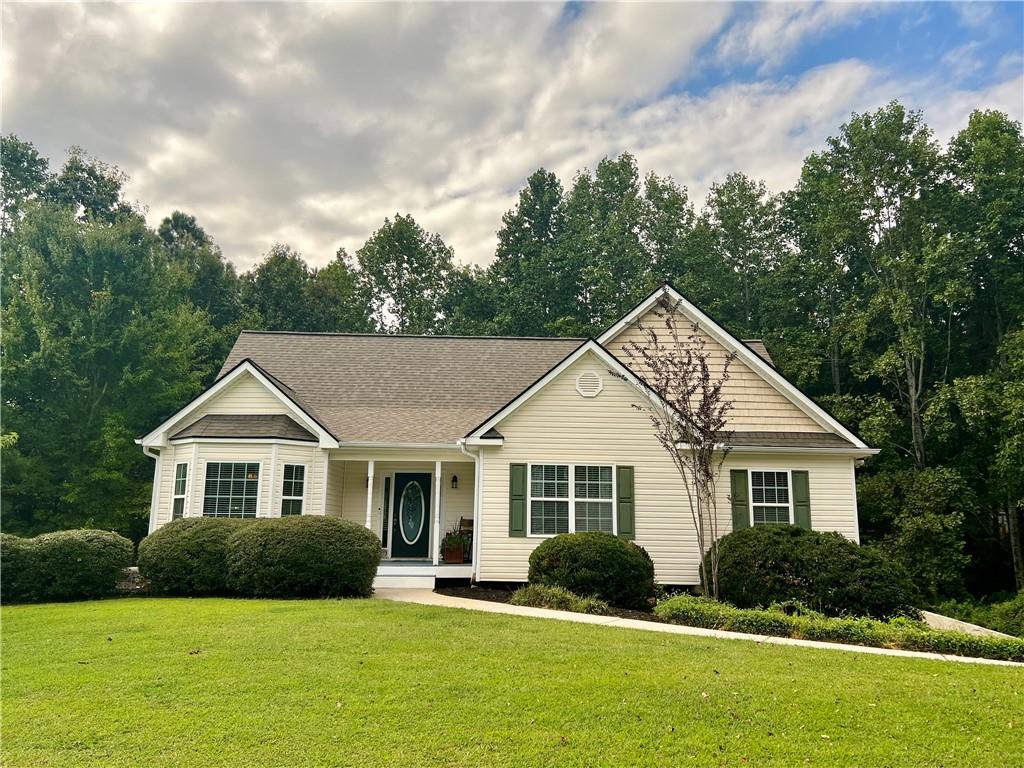 113 Nelson Ridge Drive Ball Ground, GA 30107 - Photo 32 of 33 a front view of a house with a yard and trees