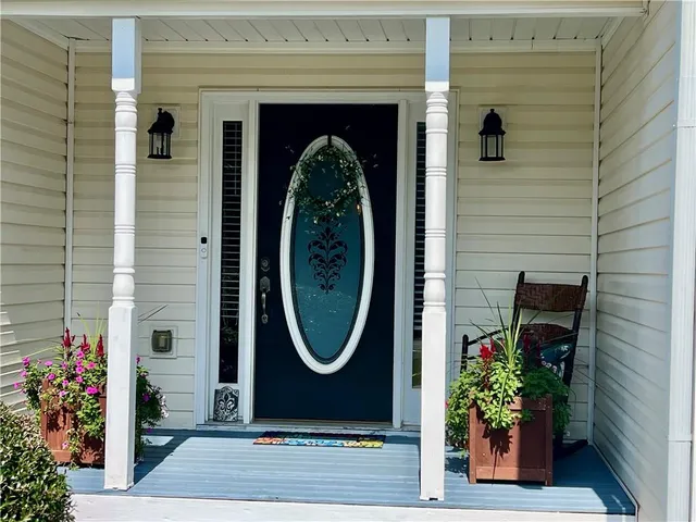 a front view of a house with a garden