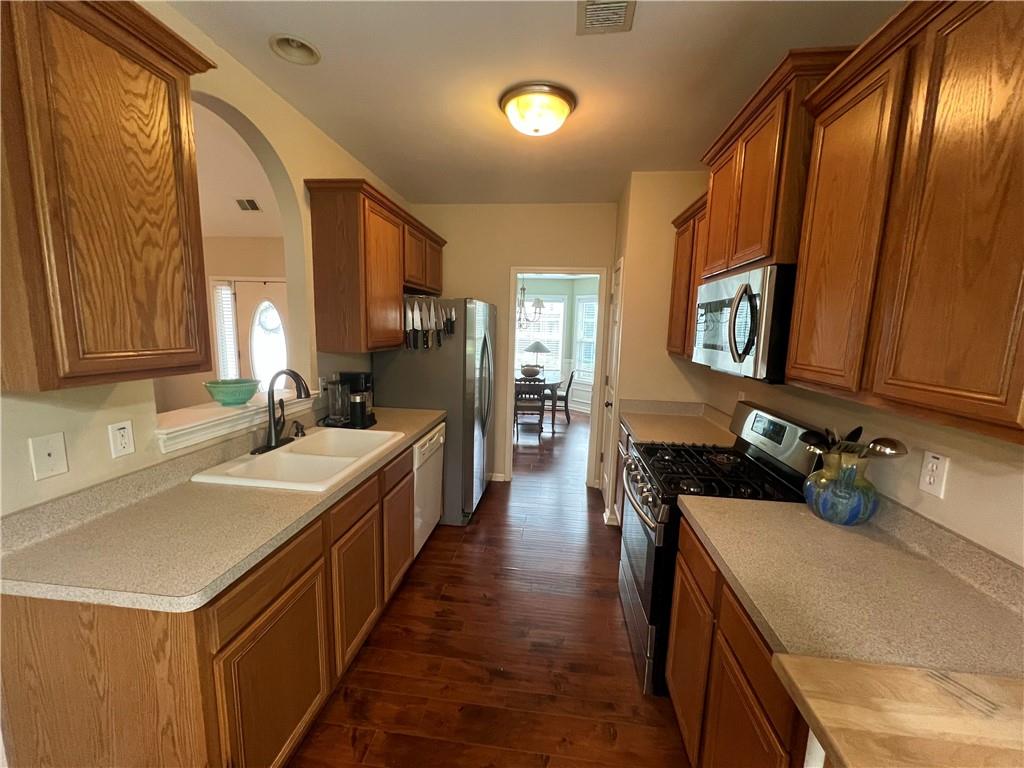 113 Nelson Ridge Drive Ball Ground, GA 30107 - Photo 10 of 33 a kitchen with a sink stove and cabinets