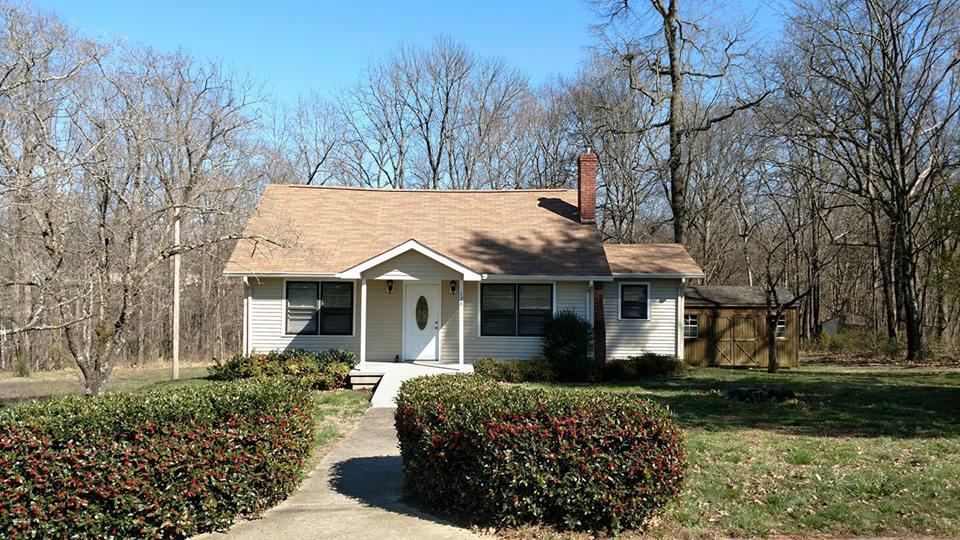 128 Butler Road Portland, TN 37148 - Photo 1 of 13 a front view of a house with a garden
