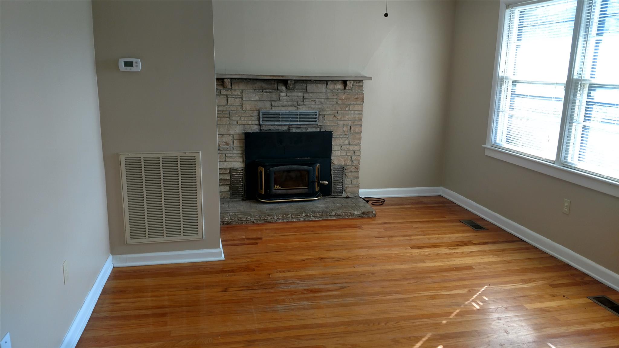 128 Butler Road Portland, TN 37148 - Photo 2 of 13 a view of a livingroom with wooden floor and a fireplace