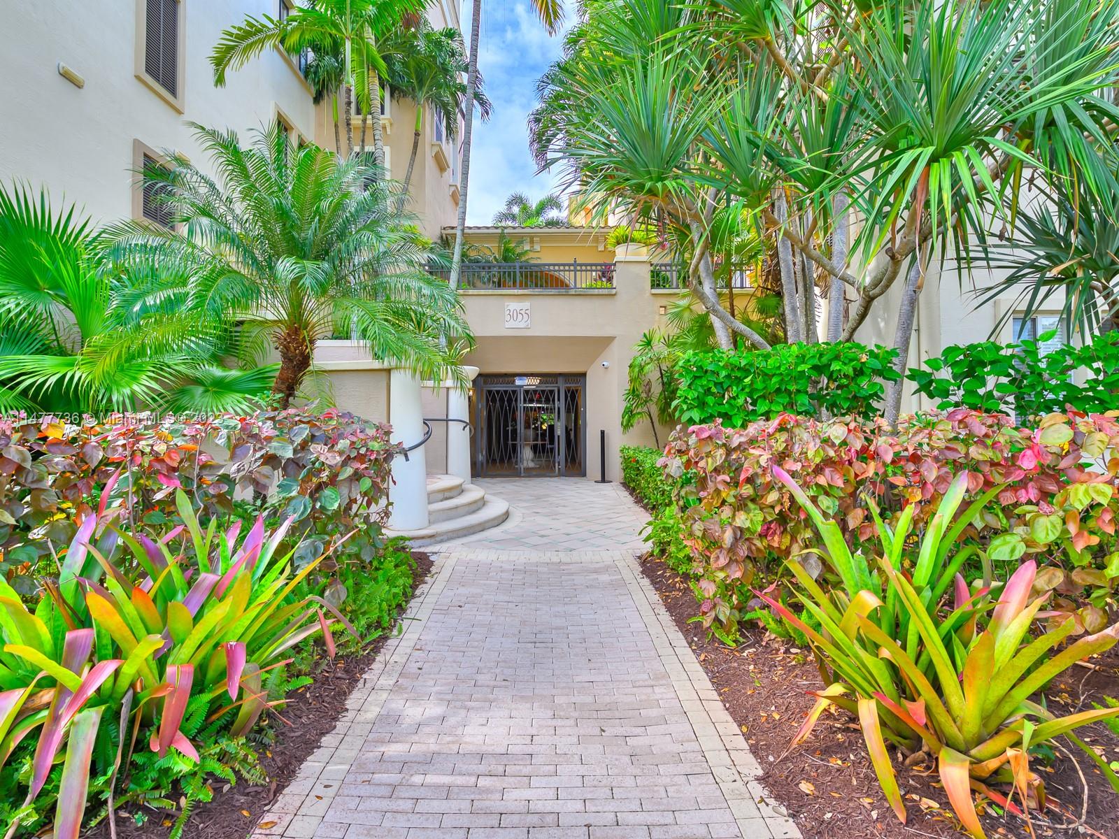 Artesia Sunrise, FL 33323 - Photo 23 of 38 a front view of a house with a garden and a yard