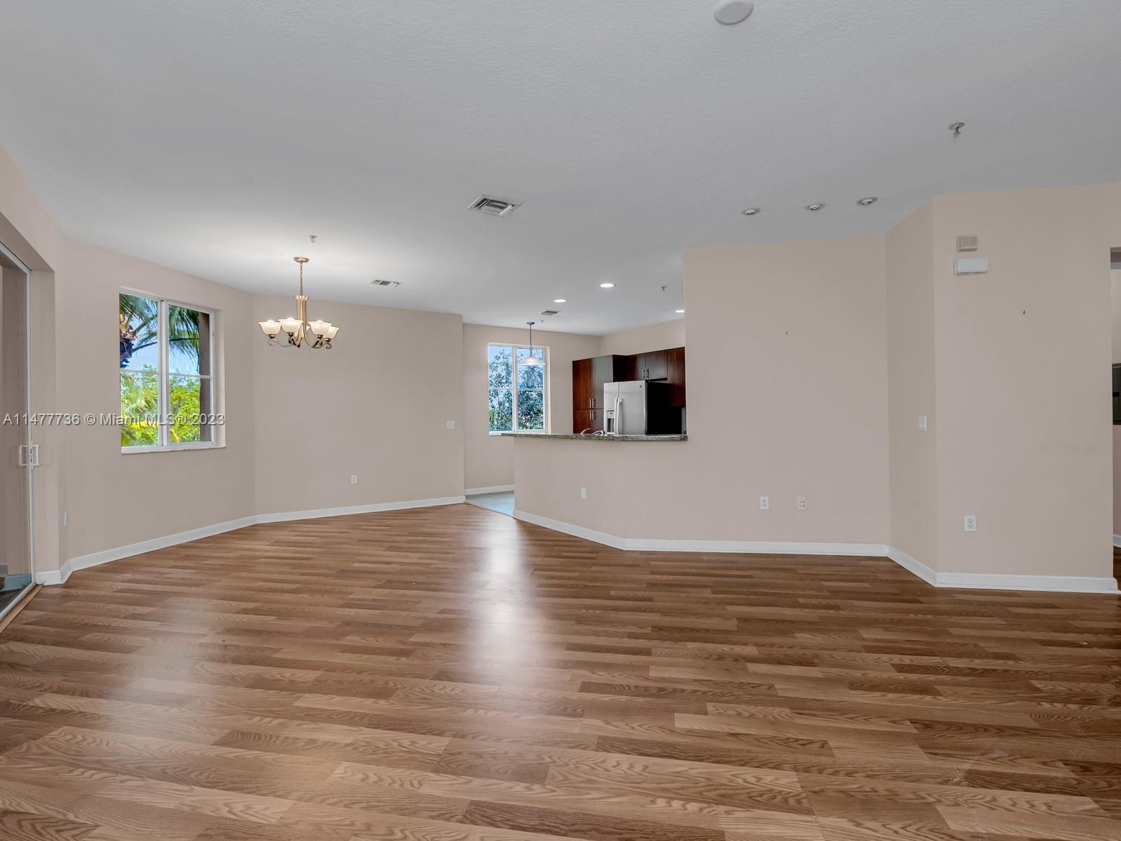 Artesia Sunrise, FL 33323 - Photo 27 of 38 a view of an empty room with window and wooden floor