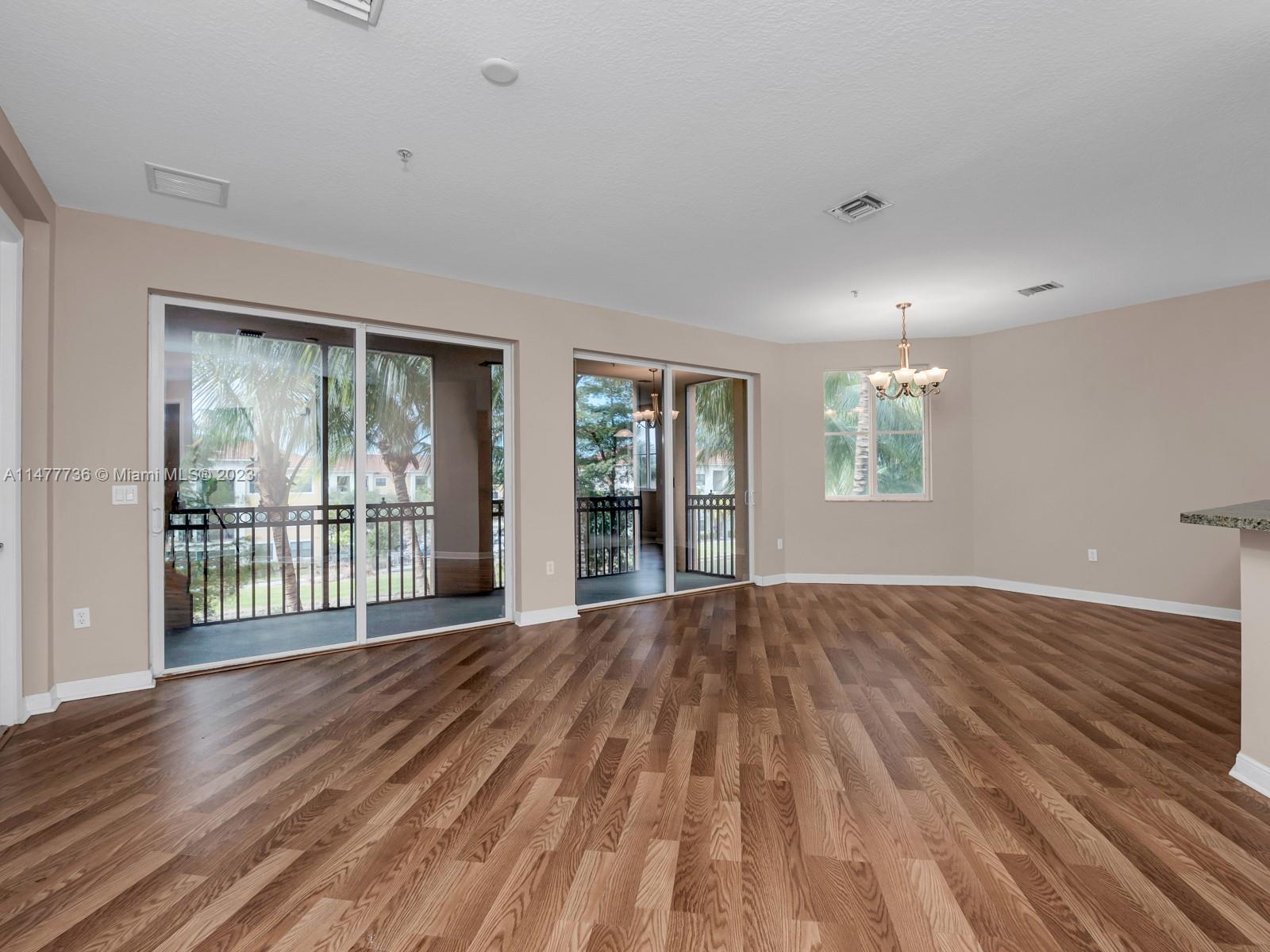 Artesia Sunrise, FL 33323 - Photo 28 of 38 a view of an empty room with wooden floor and a window