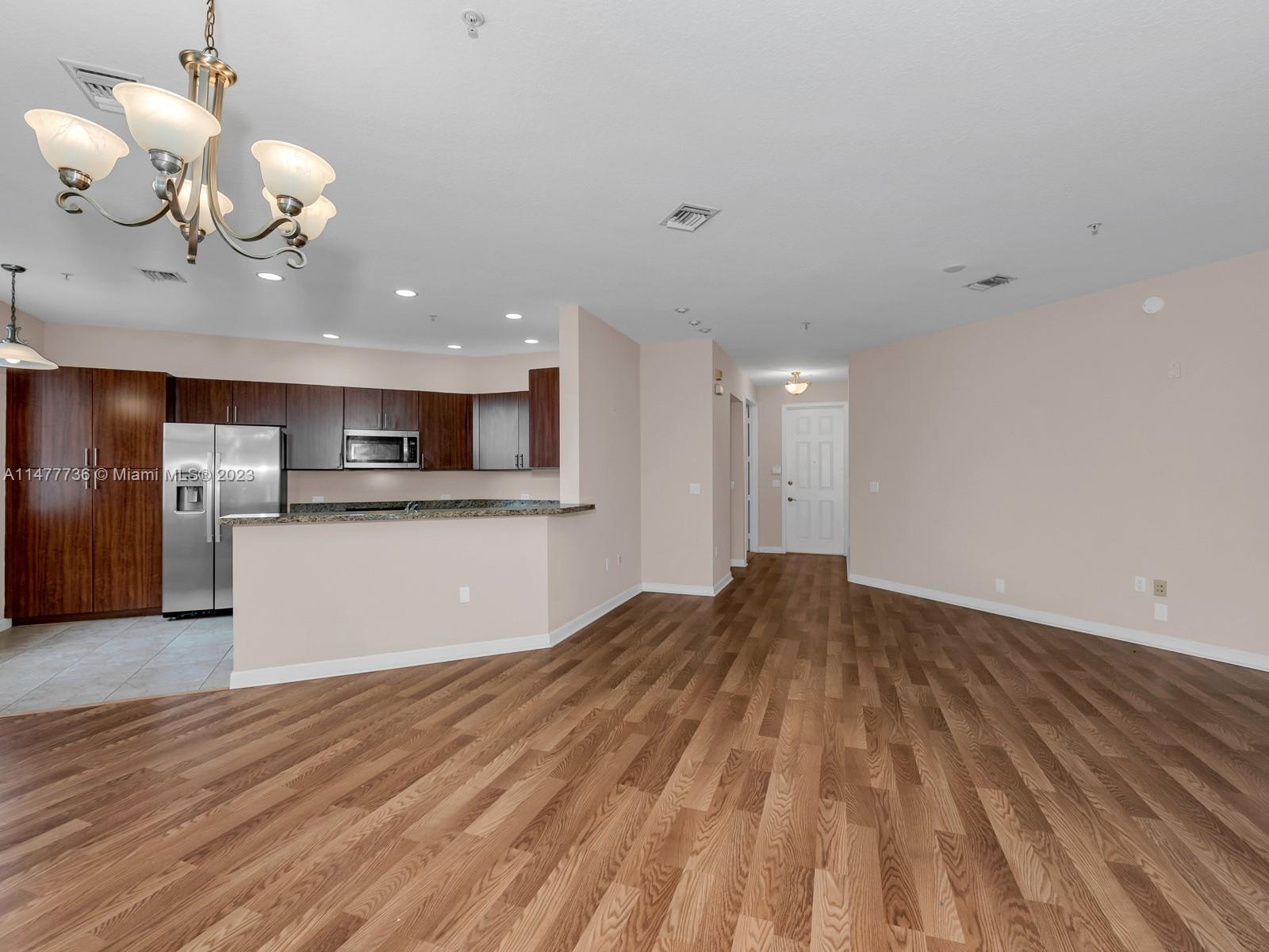 Artesia Sunrise, FL 33323 - Photo 31 of 38 a view of a kitchen with a microwave and a chandelier