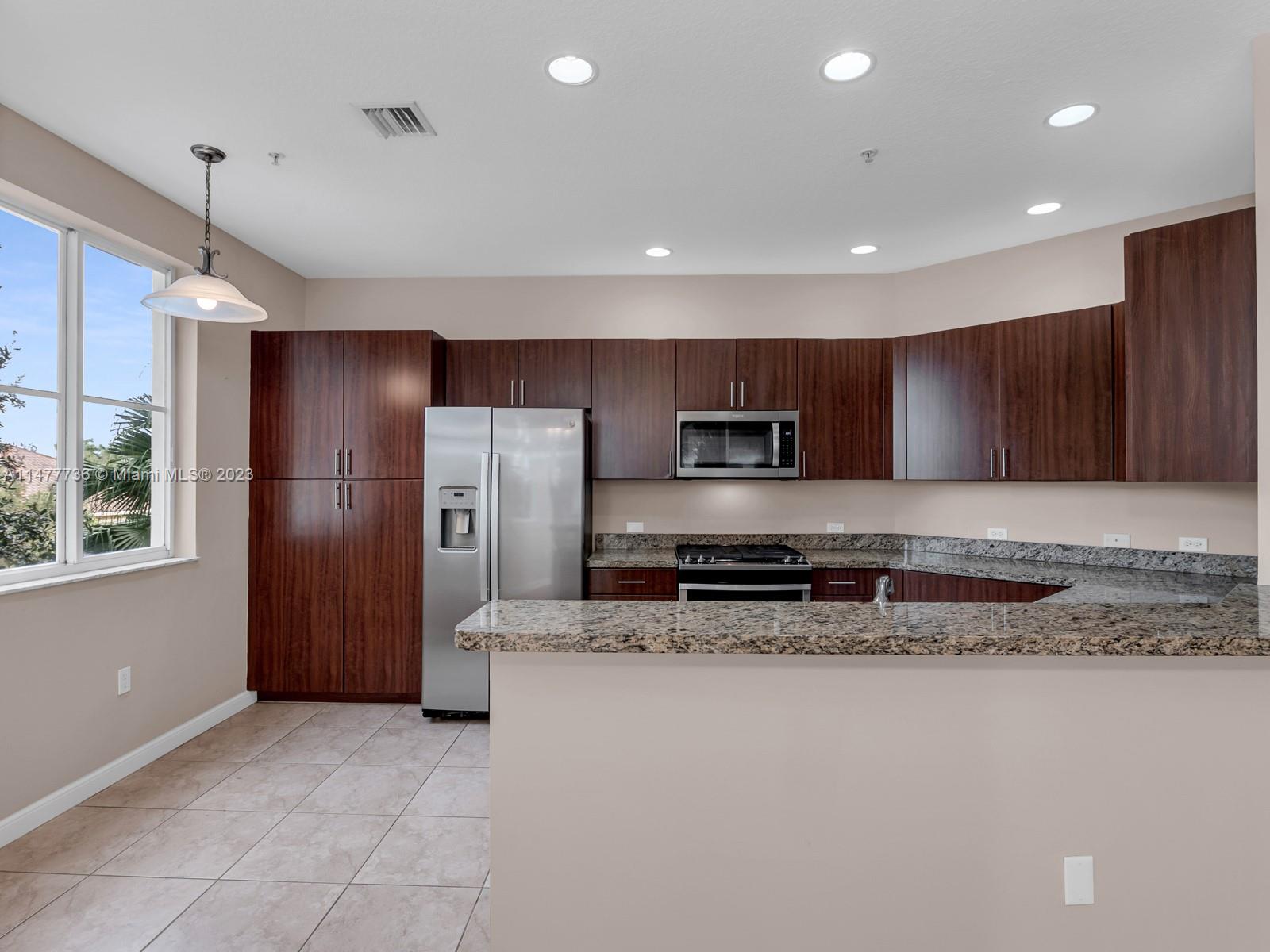 Artesia Sunrise, FL 33323 - Photo 32 of 38 a large kitchen with stainless steel appliances granite countertop a refrigerator and a stove