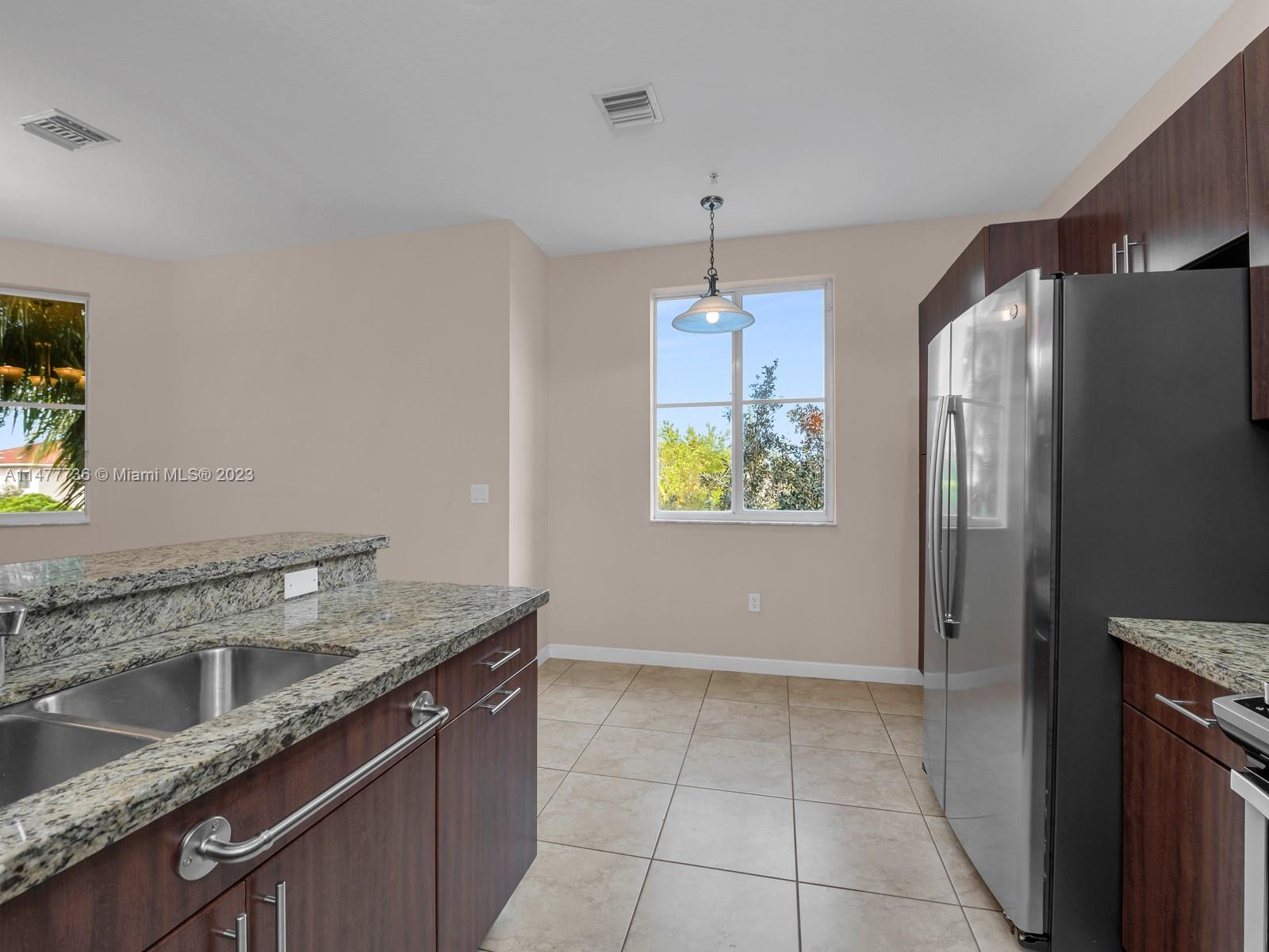 Artesia Sunrise, FL 33323 - Photo 33 of 38 a kitchen with stainless steel appliances granite countertop a refrigerator a sink a stove and island