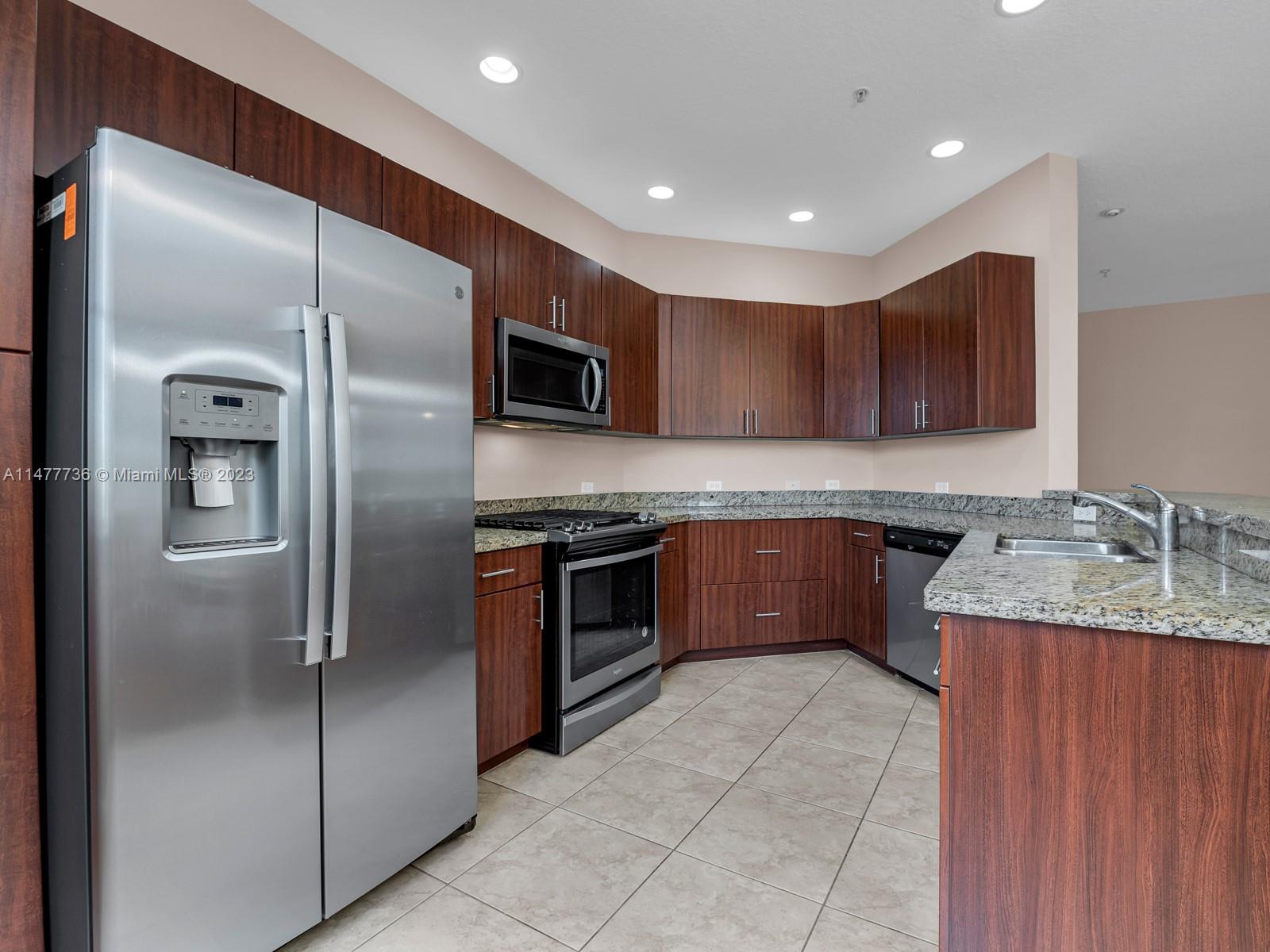 Artesia Sunrise, FL 33323 - Photo 6 of 38 a kitchen with kitchen island granite countertop stainless steel appliances and cabinets