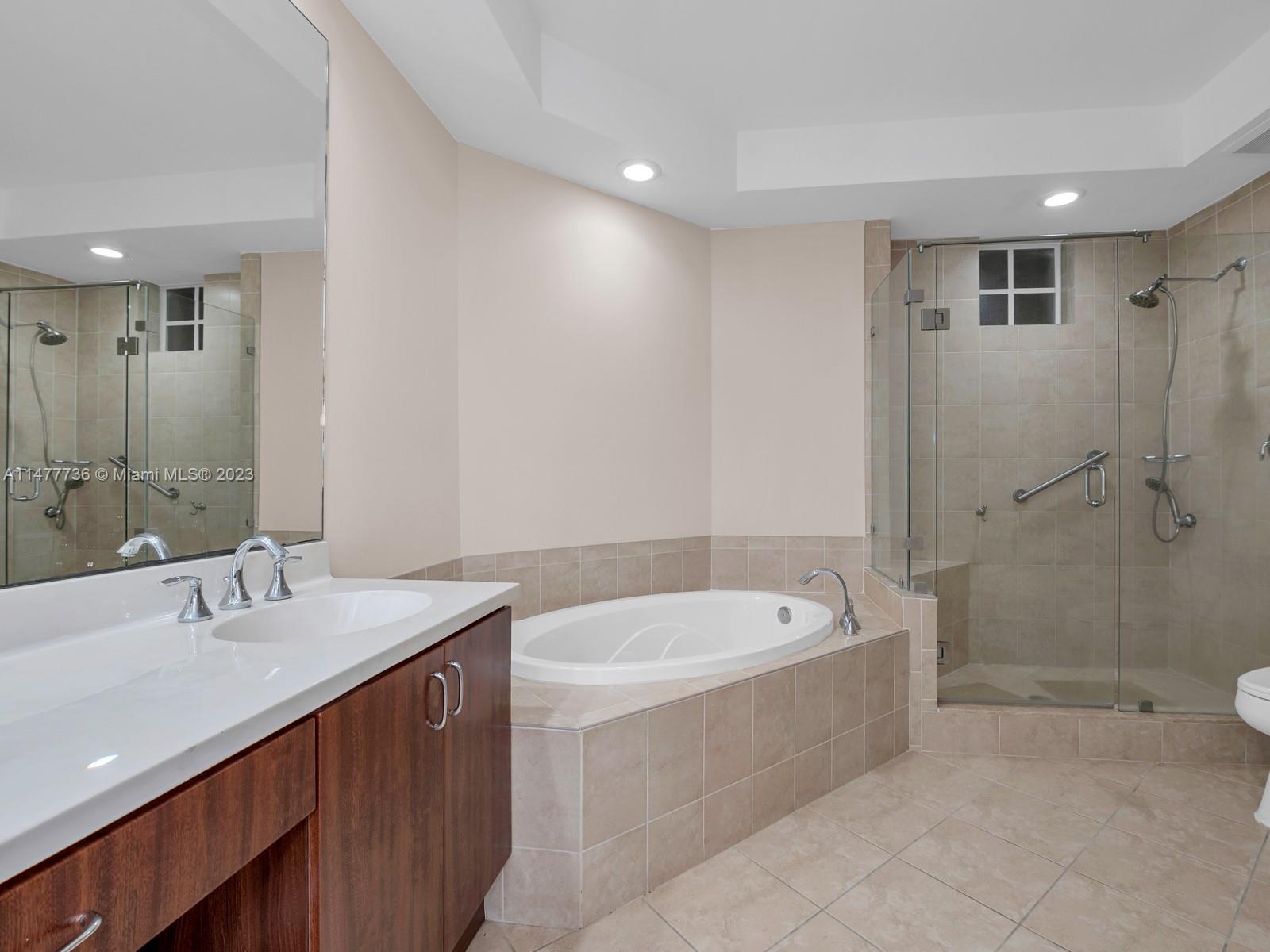 Artesia Sunrise, FL 33323 - Photo 8 of 38 a bathroom with a tub a sink and mirror