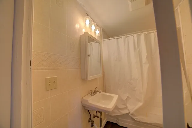 a bathroom with a sink a mirror and a shower