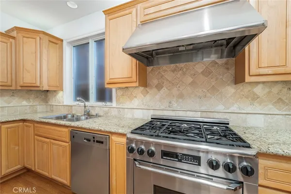 a white stove top oven sitting inside of a kitchen