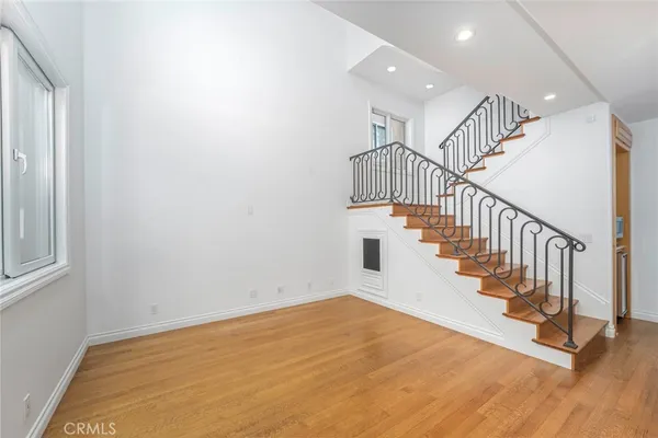 a view of entryway and hall with wooden floor