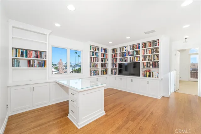 a living room with stainless steel appliances kitchen island granite countertop a refrigerator and a stove