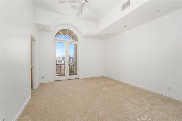 an empty room with a window and mirror