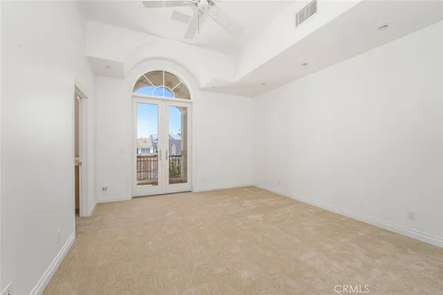 an empty room with a window and mirror