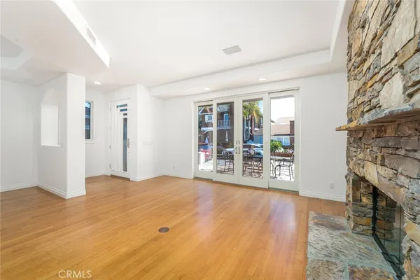 a view of an empty room with glass door and balcony