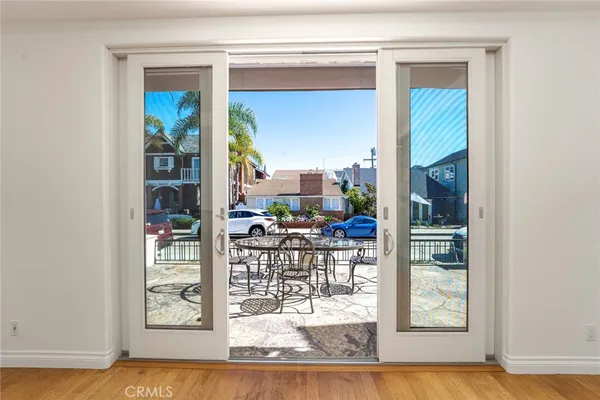 a view of a living room with a floor to ceiling window and wooden floor