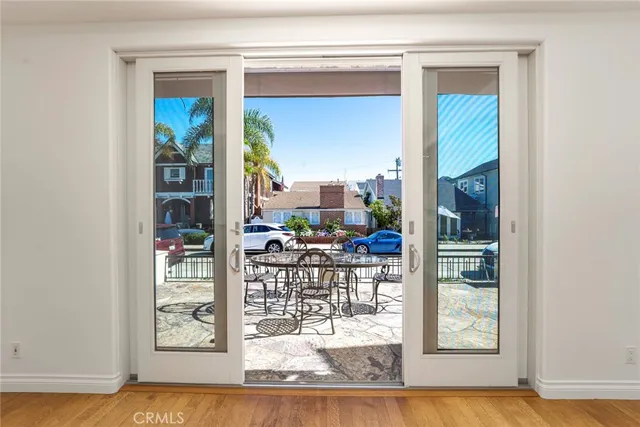 a view of a living room with a floor to ceiling window and wooden floor