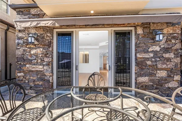 a view of a balcony with table and chairs