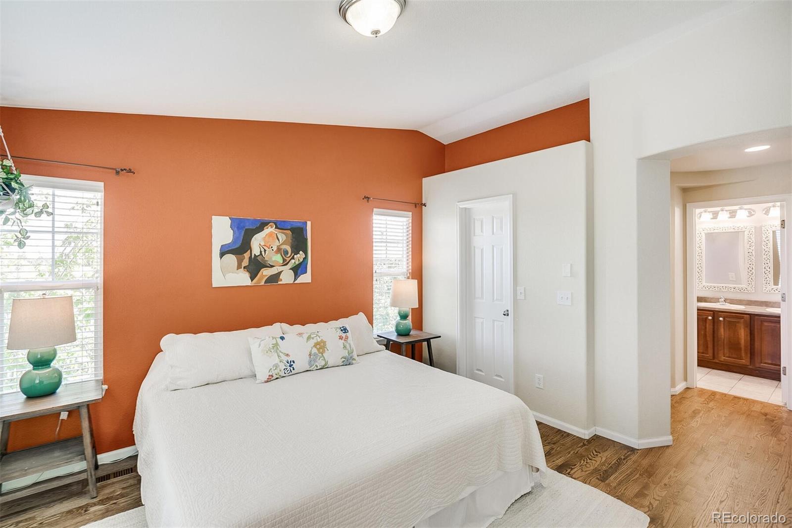 10826 Brooklawn Road Highlands Ranch, CO 80130 - Photo 17 of 29 a bedroom with a bed and wooden floor