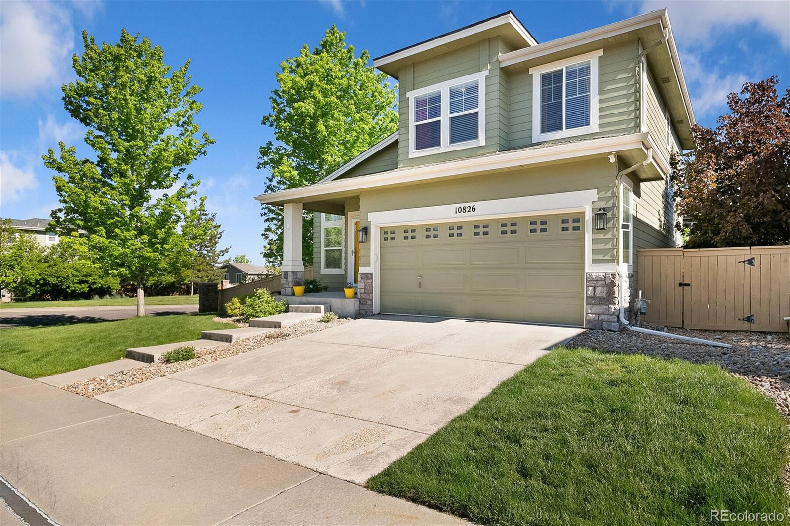 10826 Brooklawn Road Highlands Ranch, CO 80130 - Photo 3 of 29 front view of a house with a yard and a trees