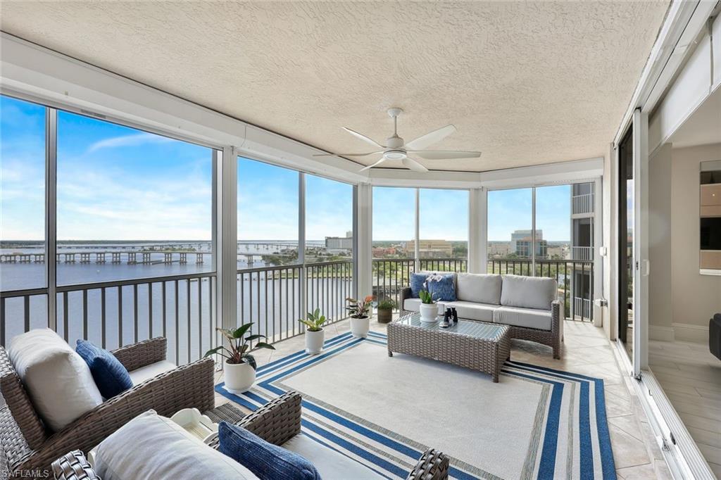 2104 West First Street, Unit 1404 Fort Myers, FL 33901 - Photo 13 of 33 a living room with furniture and a large window with balcony view