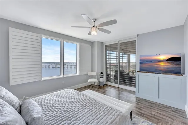 a bedroom with a bed and a large window