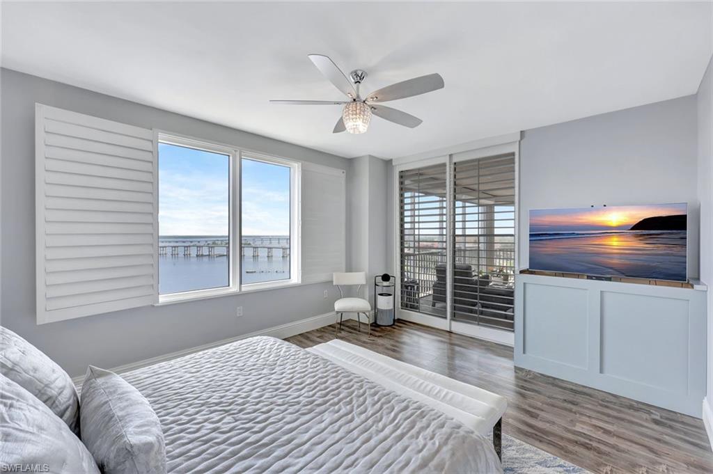 2104 West First Street, Unit 1404 Fort Myers, FL 33901 - Photo 18 of 33 a bedroom with a bed and a large window