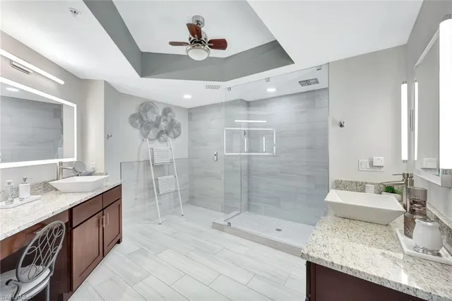 a bathroom with double vanity sink and a shower
