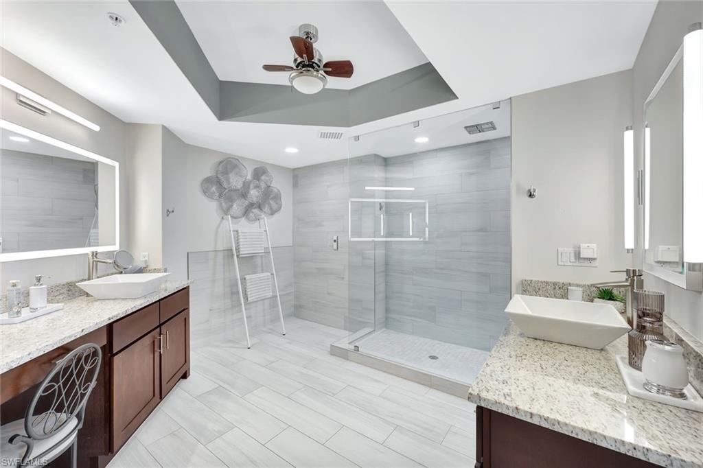 2104 West First Street, Unit 1404 Fort Myers, FL 33901 - Photo 19 of 33 a bathroom with double vanity sink and a shower