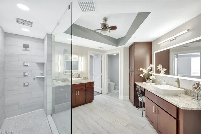 a large bathroom with a granite countertop sink mirror and shower