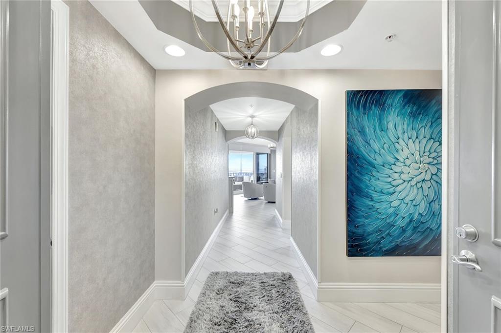 2104 West First Street, Unit 1404 Fort Myers, FL 33901 - Photo 4 of 33 a view of a hallway with a chandelier